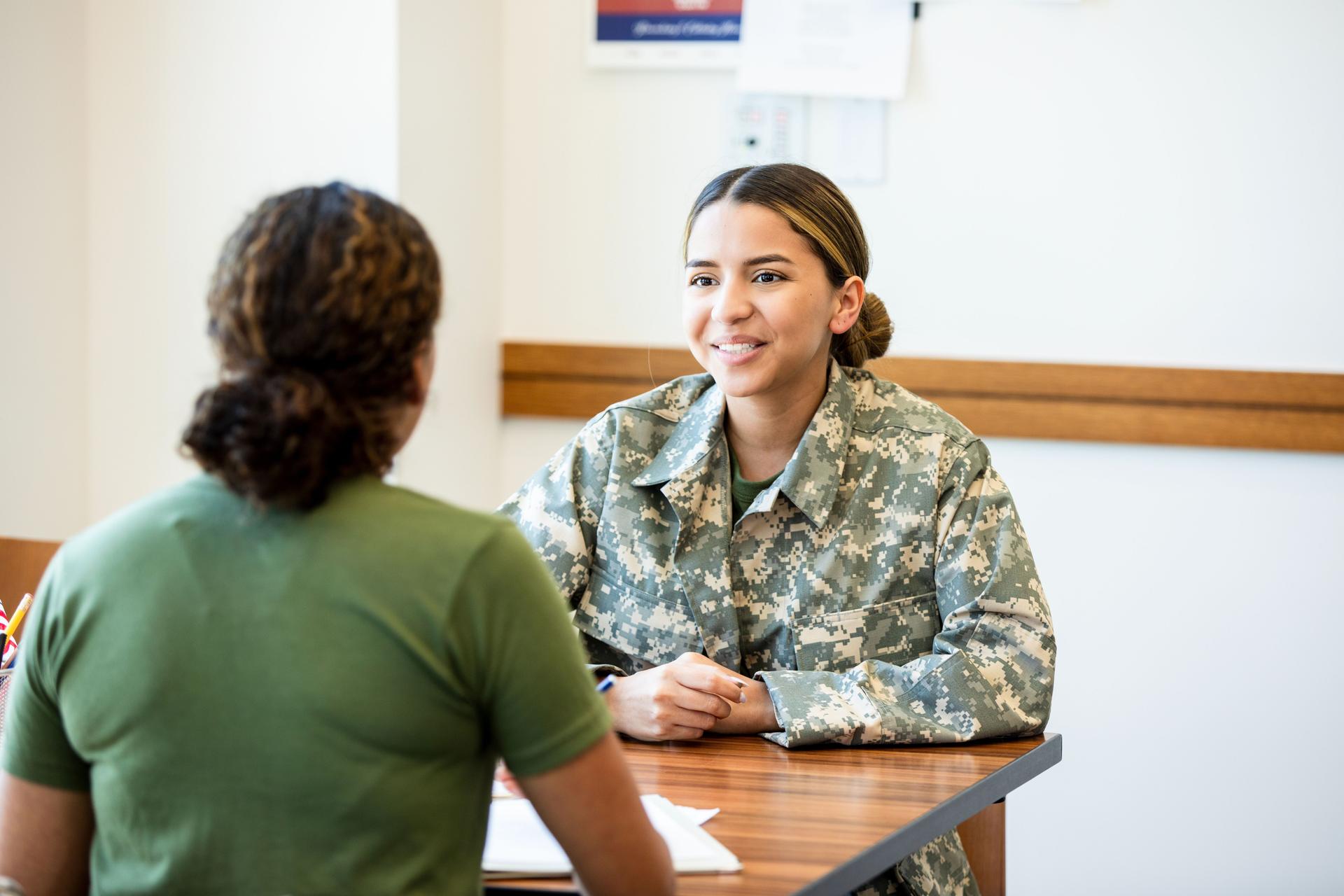 Female Veteran in Military Uniform Receiving Counseling