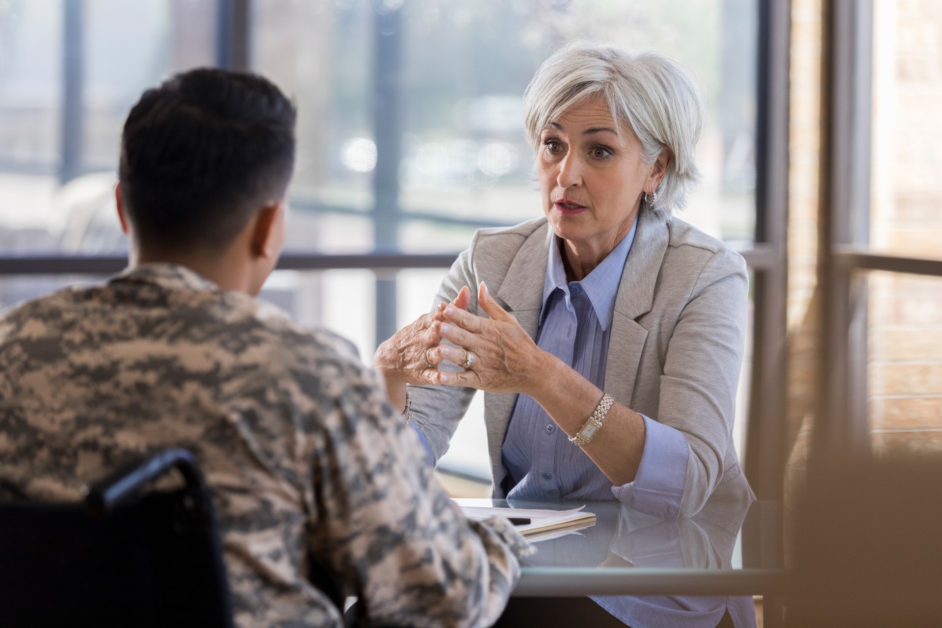Concerned therapist talks with young soldier